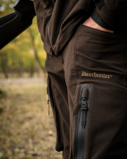 Wood coloured Deerhunter Game Pro Light Trousers on blurry background #colour_wood