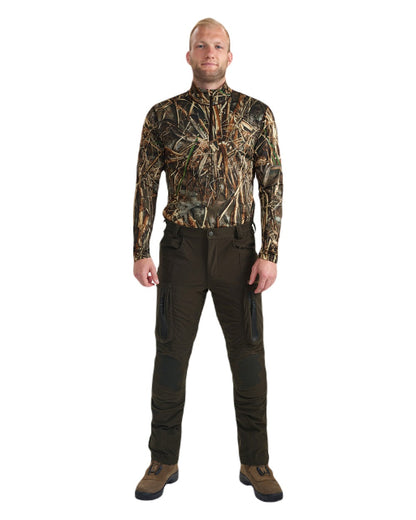 Wood coloured Deerhunter Game Pro Light Trousers on blurry background #colour_wood