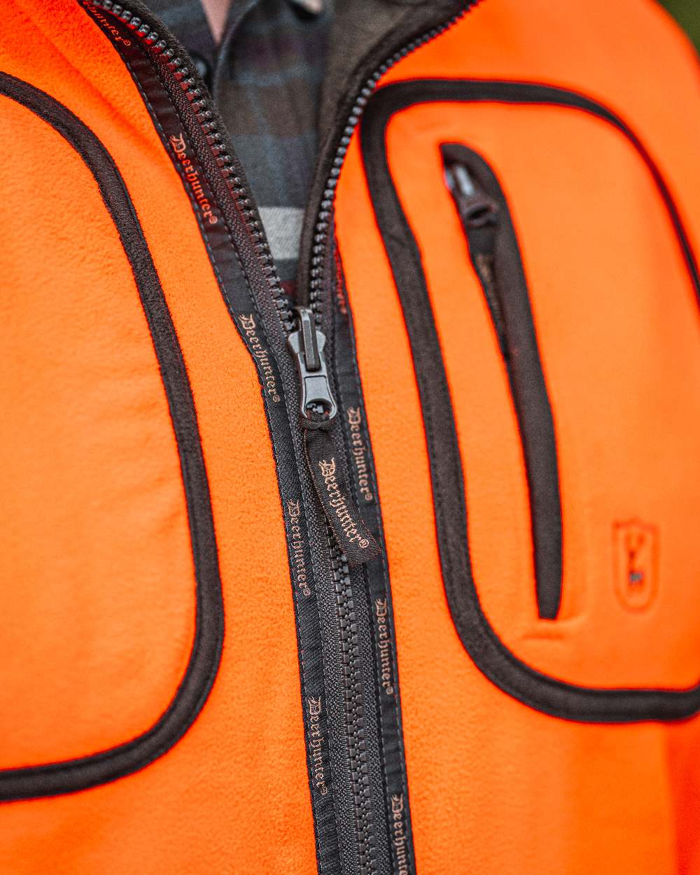 Canteen Orange coloured Deerhunter Gamekeeper Reversible Bonded Fleece Jacket on blurry background #colour_canteen-orange