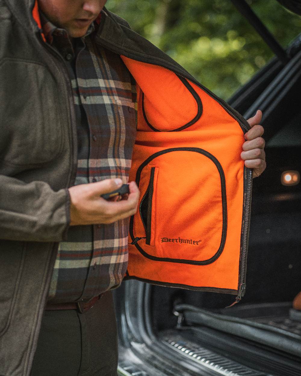 Canteen Orange coloured Deerhunter Gamekeeper Reversible Bonded Fleece Jacket on blurry background #colour_canteen-orange