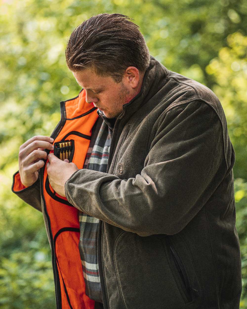 Canteen Orange coloured Deerhunter Gamekeeper Reversible Bonded Fleece Jacket on blurry background #colour_canteen-orange
