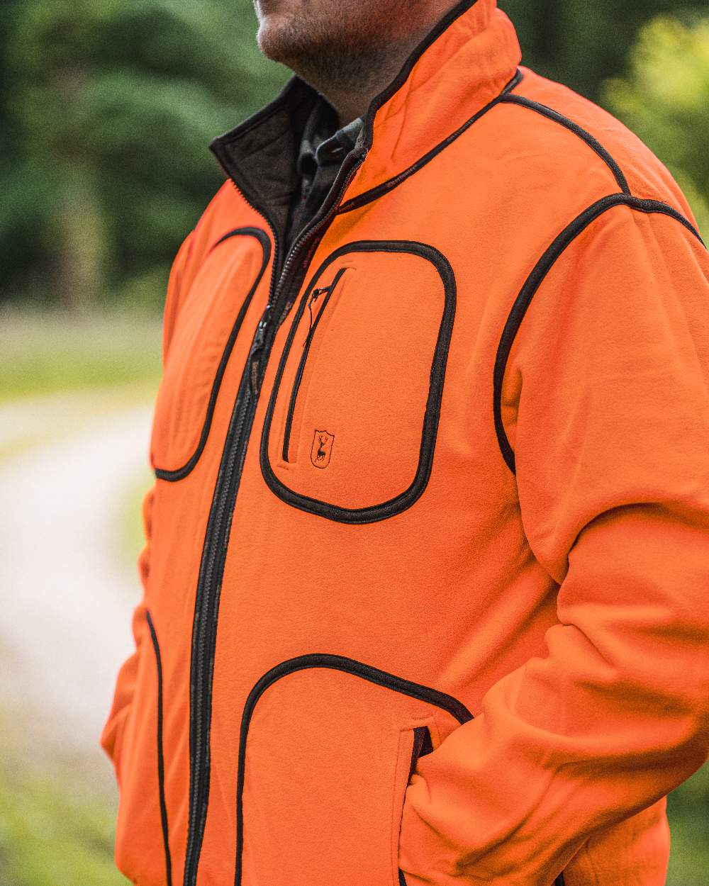 Canteen Orange coloured Deerhunter Gamekeeper Reversible Bonded Fleece Jacket on blurry background #colour_canteen-orange