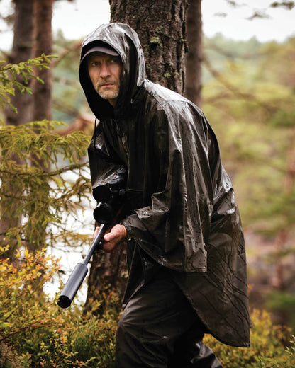 Art Green coloured Deerhunter Hurricane Rain Poncho on forest background #colour_art-green