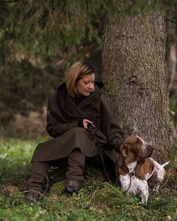 Canteen Coloured Deerhunter Ladies Waterproof Rain Poncho on forest background #colour_canteen