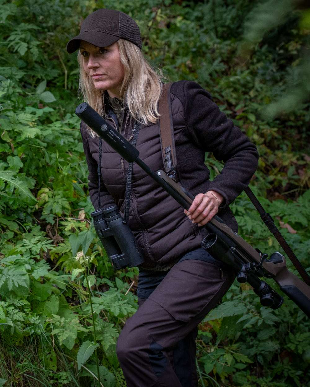 Dark Prune coloured Deerhunter Lady Ann Trousers on forest background #colour_dark-prune
