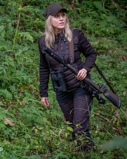Dark Prune coloured Deerhunter Lady Ann Trousers on forest background #colour_dark-prune