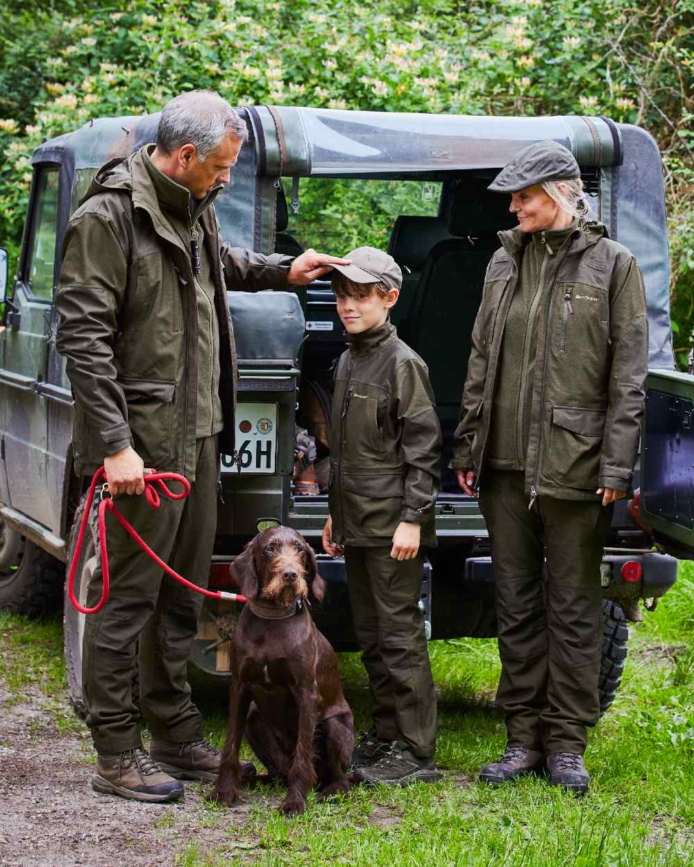 Olive Night Melange Coloured Deerhunter Lady Chasse Jacket on forest background #colour_olive-night-melange