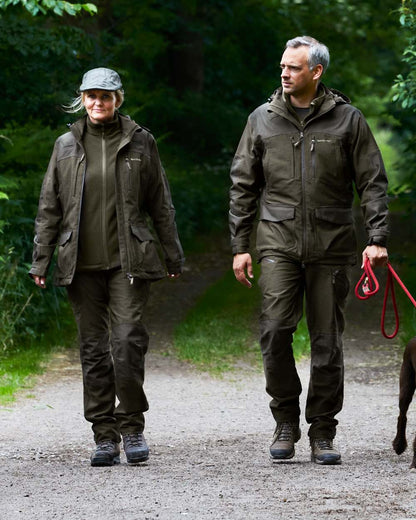 Olive Night Melange Coloured Deerhunter Lady Chasse Jacket on forest background #colour_olive-night-melange