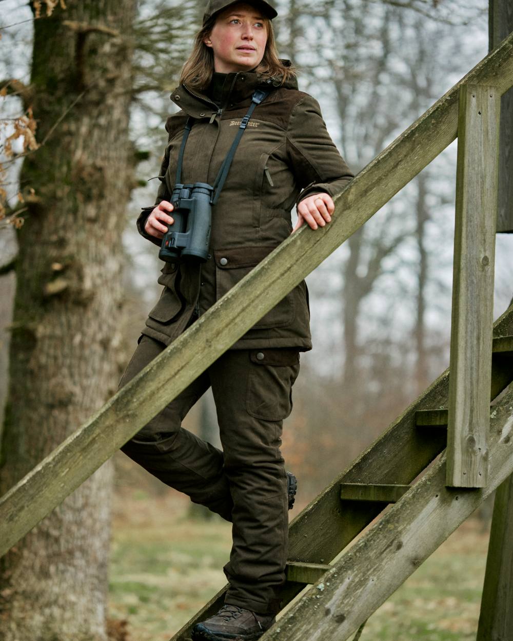 Tarmac Green coloured Deerhunter Lady Eagle Winter Trousers on forest background #colour_tarmac-green