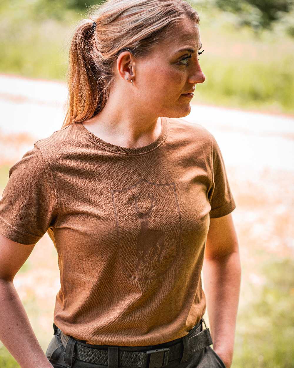 Butternut coloured Deerhunter Lady Logo T-Shirt on blurry background #colour_butternut
