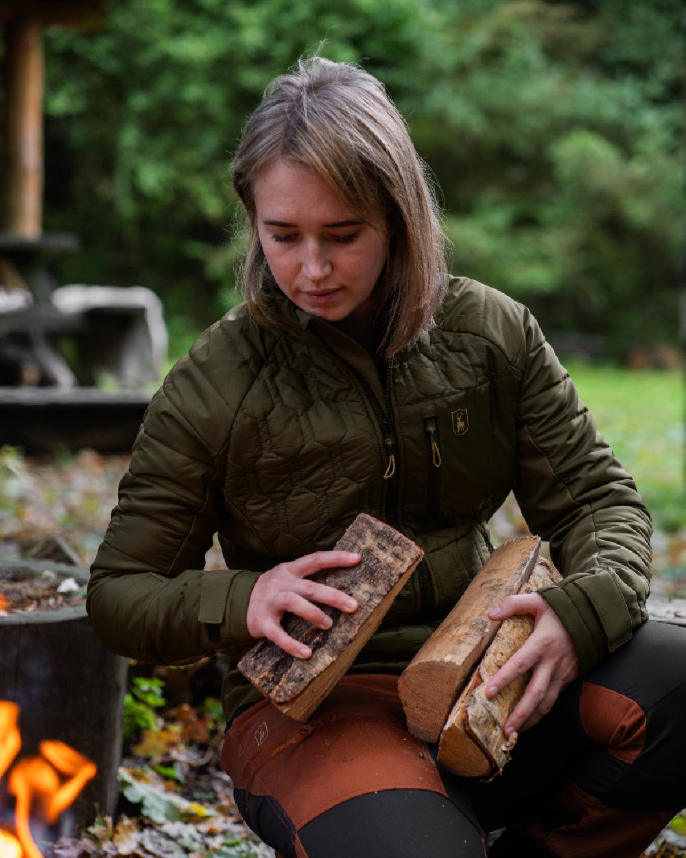 Forest Green coloured Deerhunter Lady Mossdale Quilted Jacket on forest background #colour_forest-green