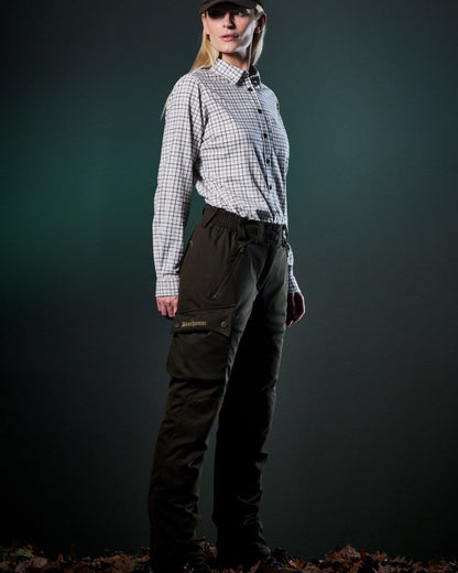 Art Green coloured Deerhunter Lady Muflon Pro Trousers on forest background #colour_art-green