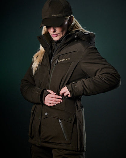 Art Green coloured Deerhunter Lady Muflon Pro Winter Jacket on forest background #colour_art-green