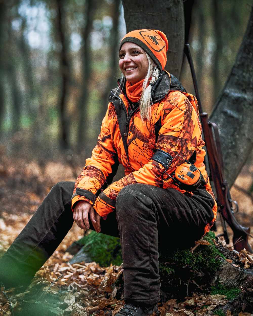 Orange coloured Deerhunter Logo Neck Tube on forest background #colour_orange