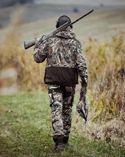 Realtree Max-5 coloured Deerhunter Mallard Trousers on grassy background #colour_realtree-max-5