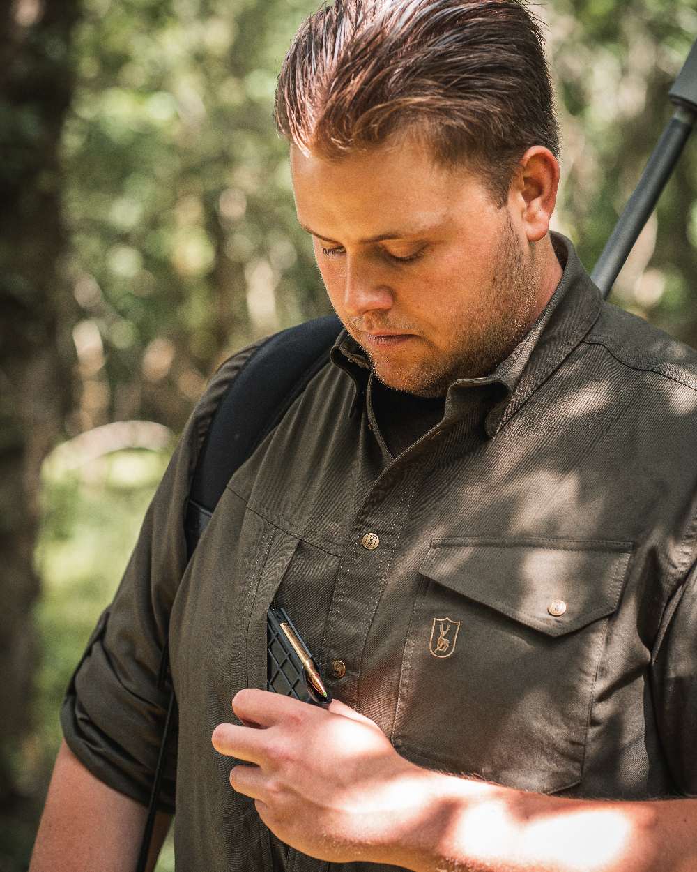 Forest Green coloured Deerhunter Matobo Shirt on blurry background #colour_forest-green