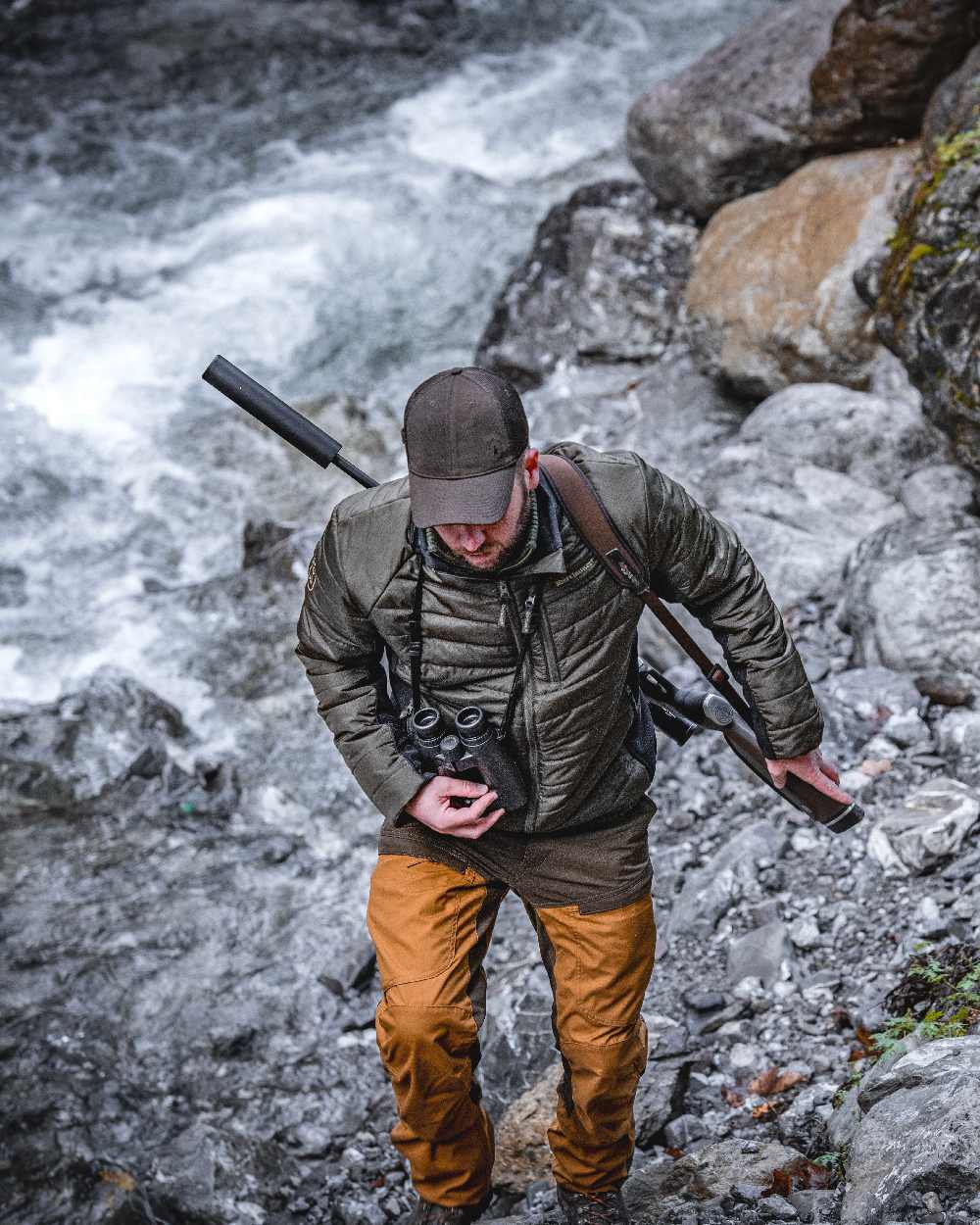 Adventure Green coloured Deerhunter Moor Padded Softshell Jacket on lake background #colour_adventure-green