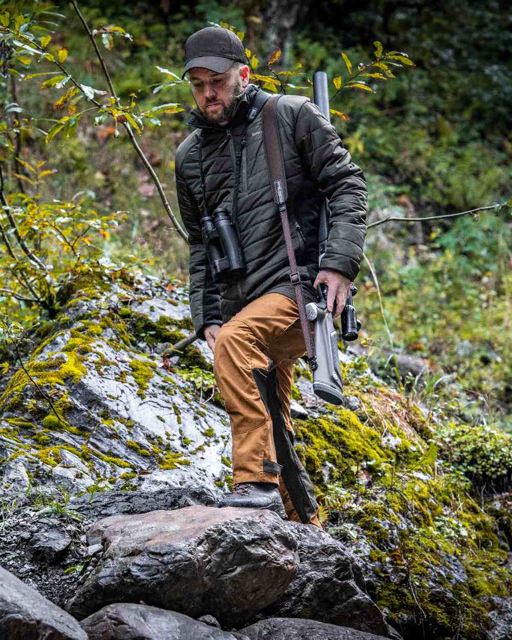 Adventure Green coloured Deerhunter Moor Padded Softshell Jacket on forest background #colour_adventure-green