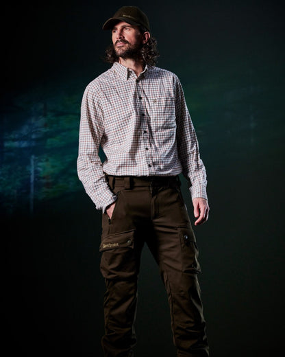 Art Green coloured Deerhunter Mens Muflon Pro Light Trousers on forest background #colour_art-green