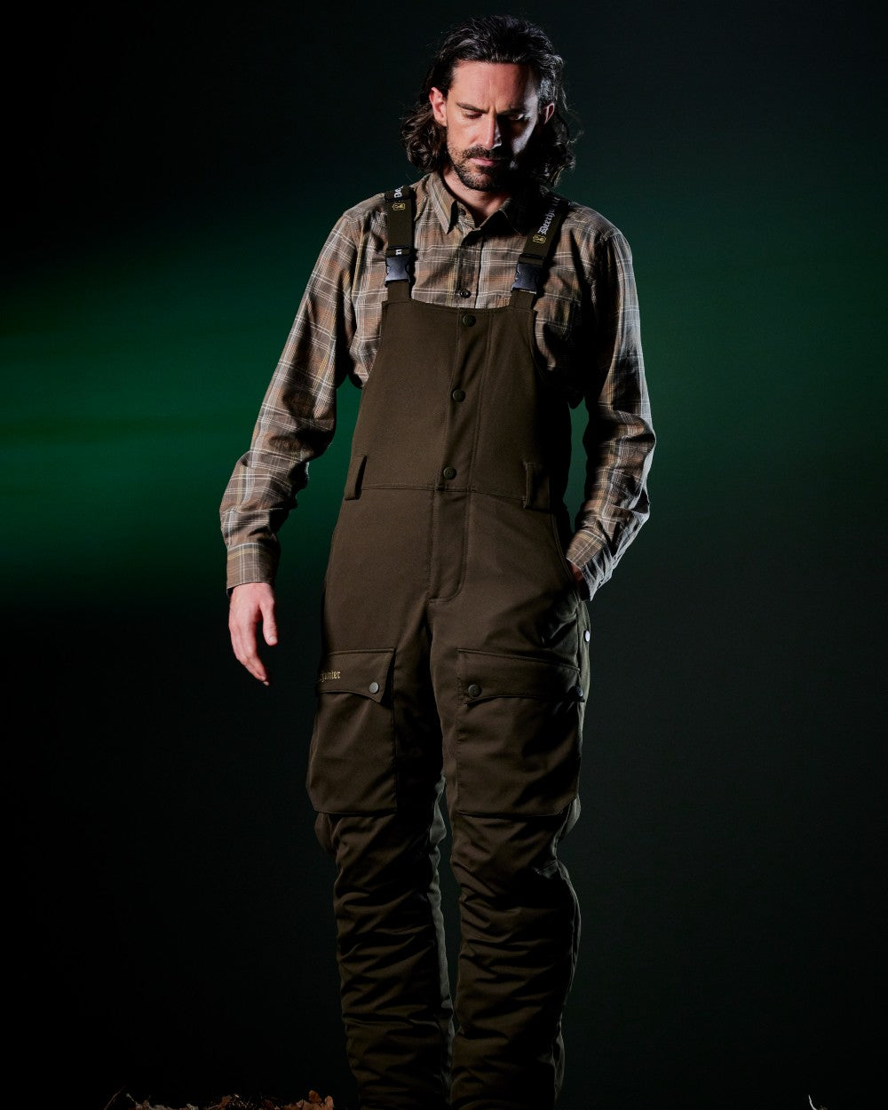 Art Green coloured Deerhunter Mens Muflon Pro Winter Bib Trousers on forest background #colour_art-green