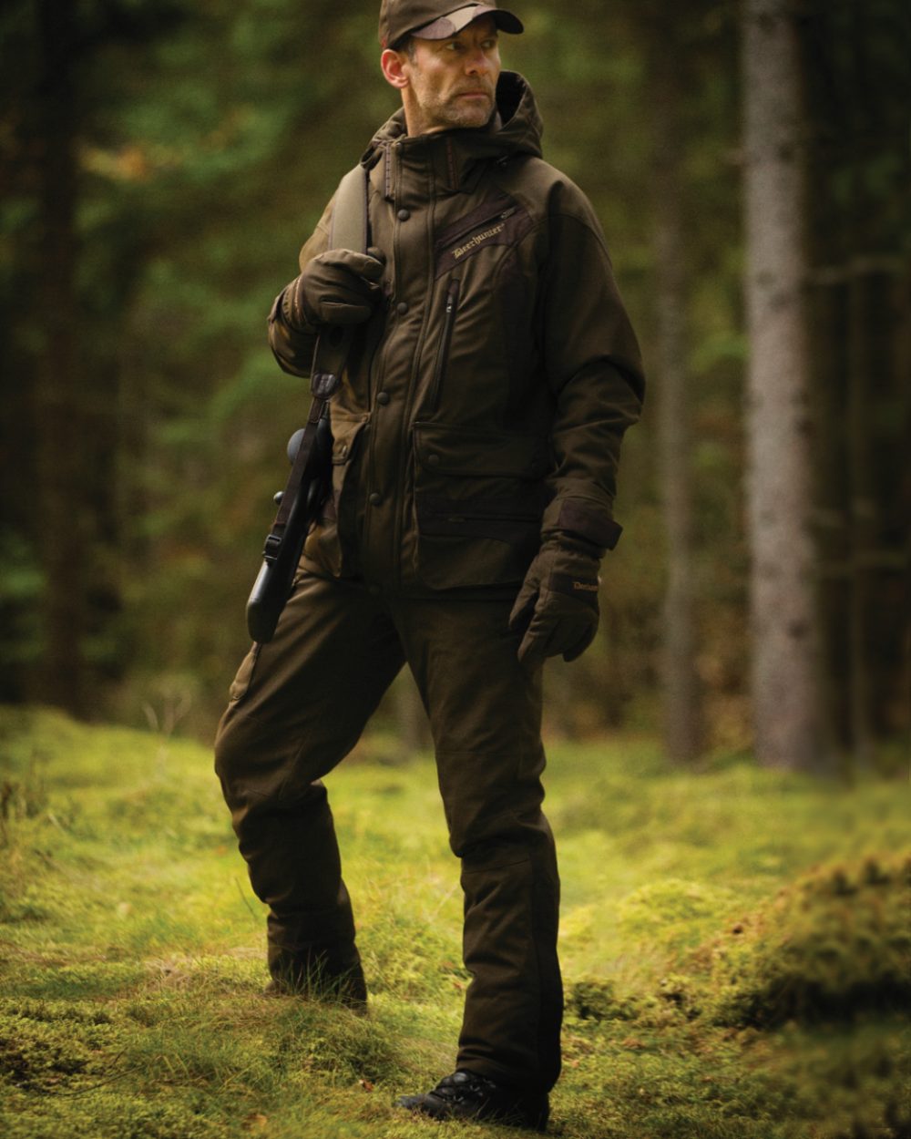 Art Green coloured Deerhunter Muflon Trousers on forest background #colour_art-green