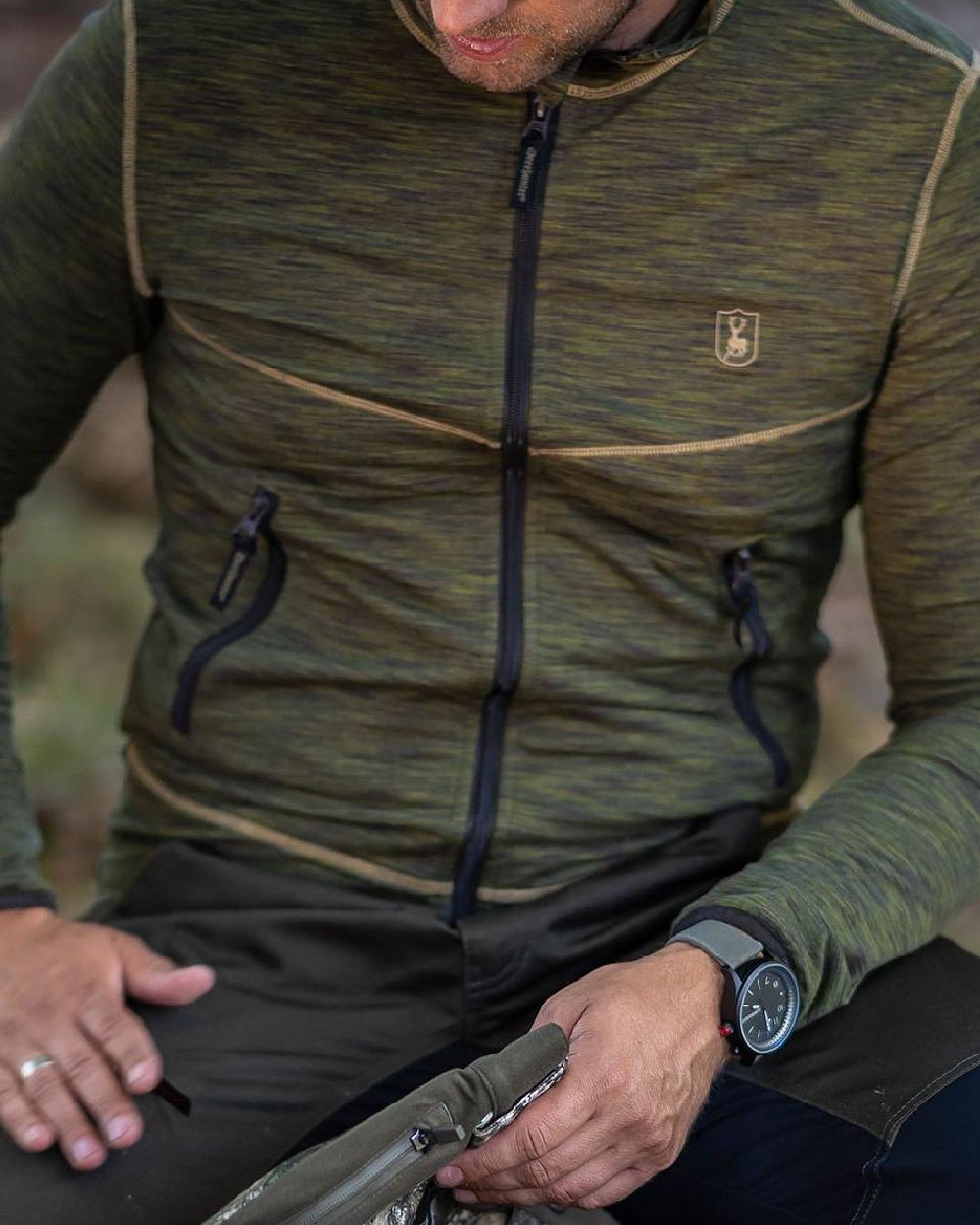 Green Melange coloured Deerhunter Norden Fleece Jacket on forest background #colour_green-melange