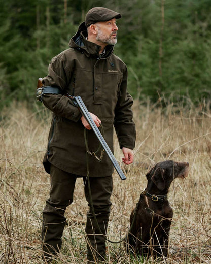 Peat Coloured Deerhunter Pro Gamekeeper Boot Trousers on forest background #colour_peat