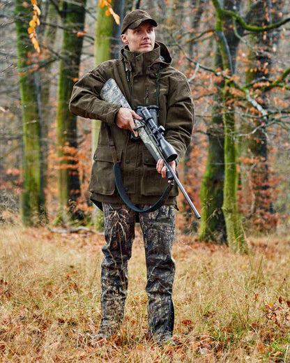 Peat Coloured Deerhunter Pro Gamekeeper Boot Trousers on forest background #colour_peat