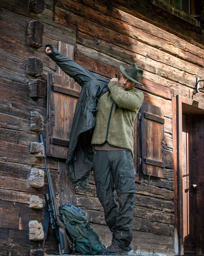 Elmwood coloured Deerhunter Ram Trousers with Reinforcement on wooden wall background #colour_elmwood