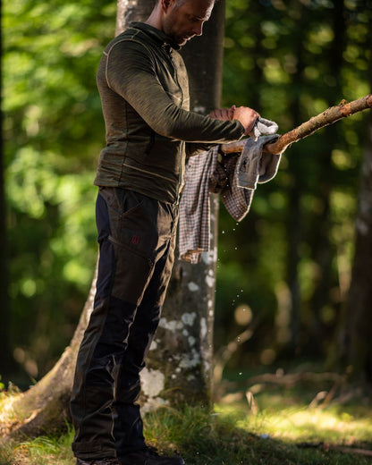Adventure Green Coloured Deerhunter Rogaland Contrast Stretch Trousers on forest background #colour_adventure-green