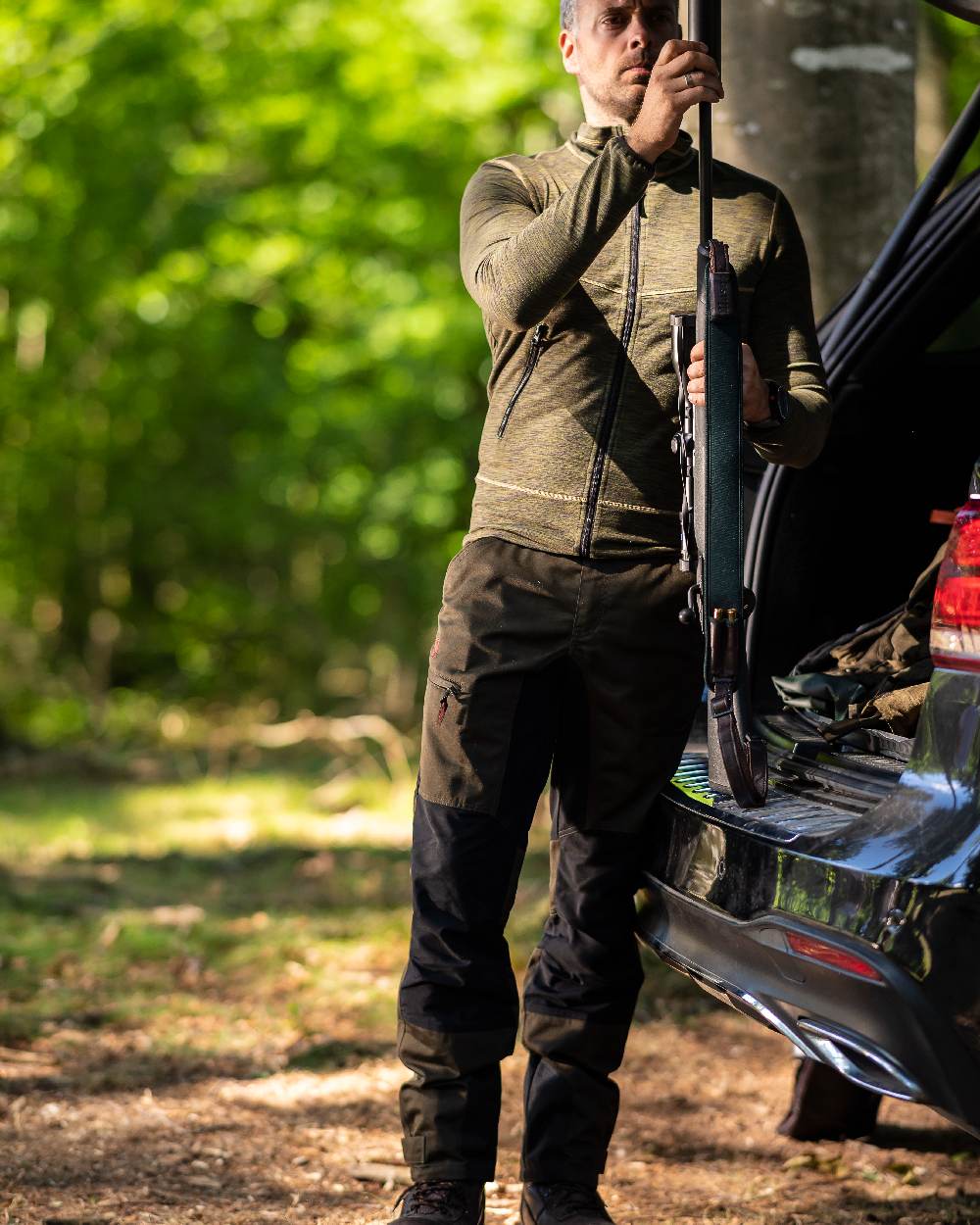 Adventure Green Coloured Deerhunter Rogaland Contrast Stretch Trousers on forest background #colour_adventure-green