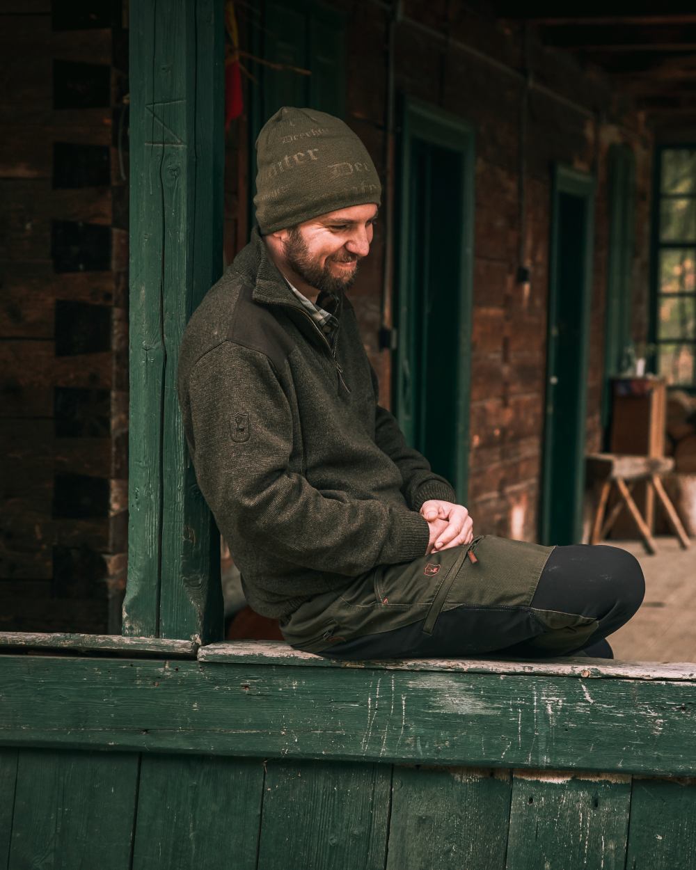 Dark Elm coloured Deerhunter Sheffield Zip Neck Sweater on house background #colour_dark-elm