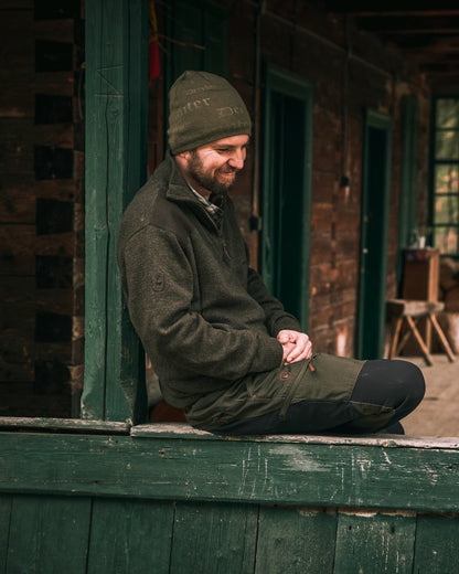Dark Elm coloured Deerhunter Sheffield Zip Neck Sweater on house background #colour_dark-elm