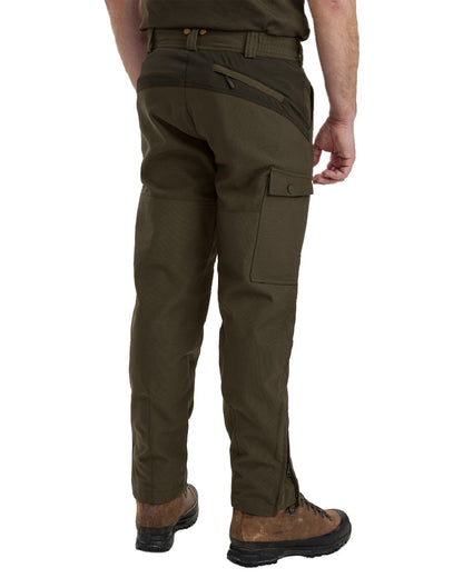 Palm Green coloured Deerhunter Strike Extreme Boot Trousers on white background #colour_palm-green