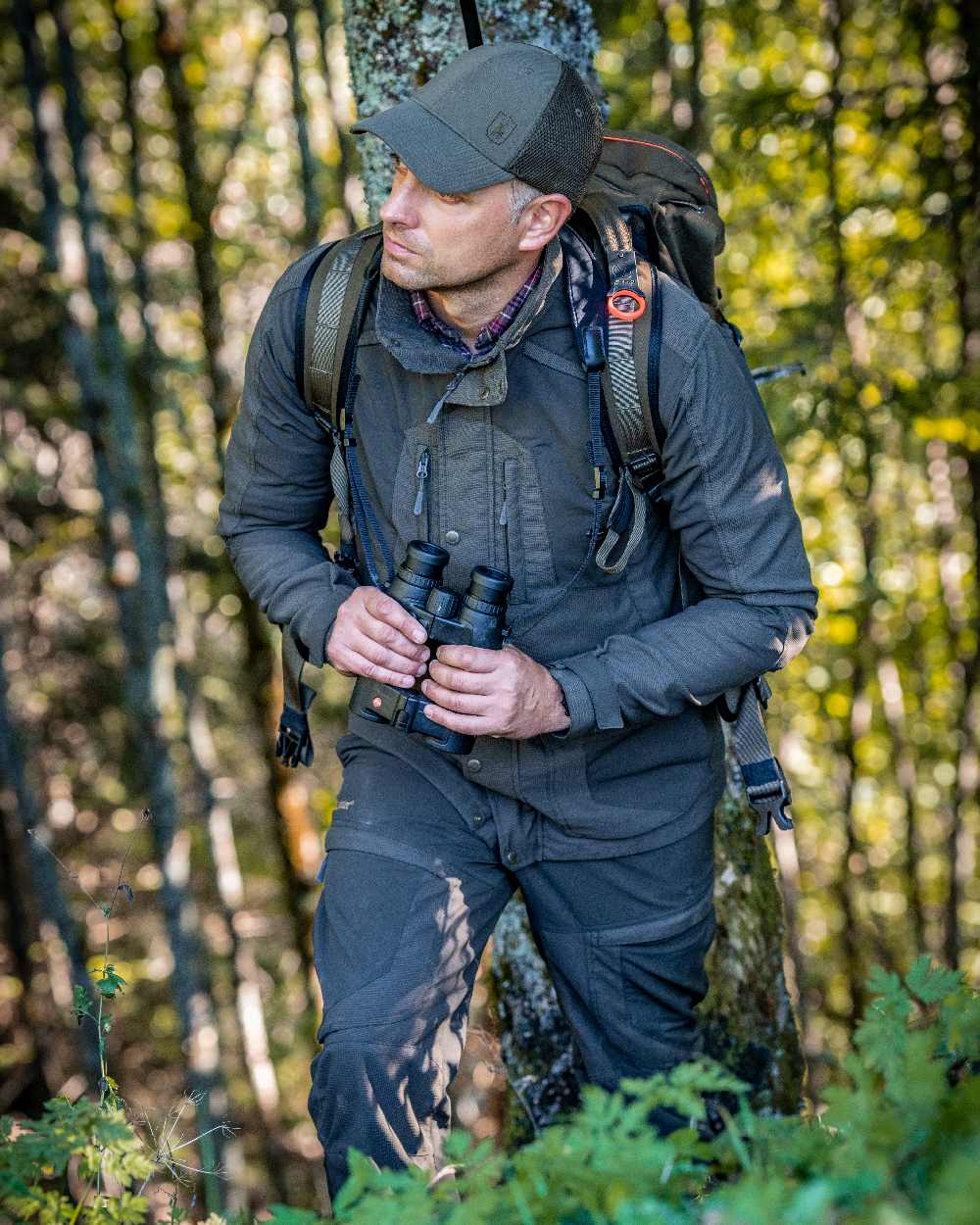 Palm Green coloured Deerhunter Strike Extreme Jacket on forest background #colour_palm-green