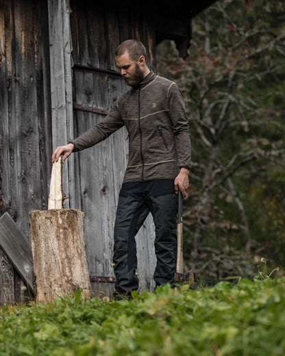 Black Ink coloured Deerhunter Strike Trousers on forest background #colour_black-ink