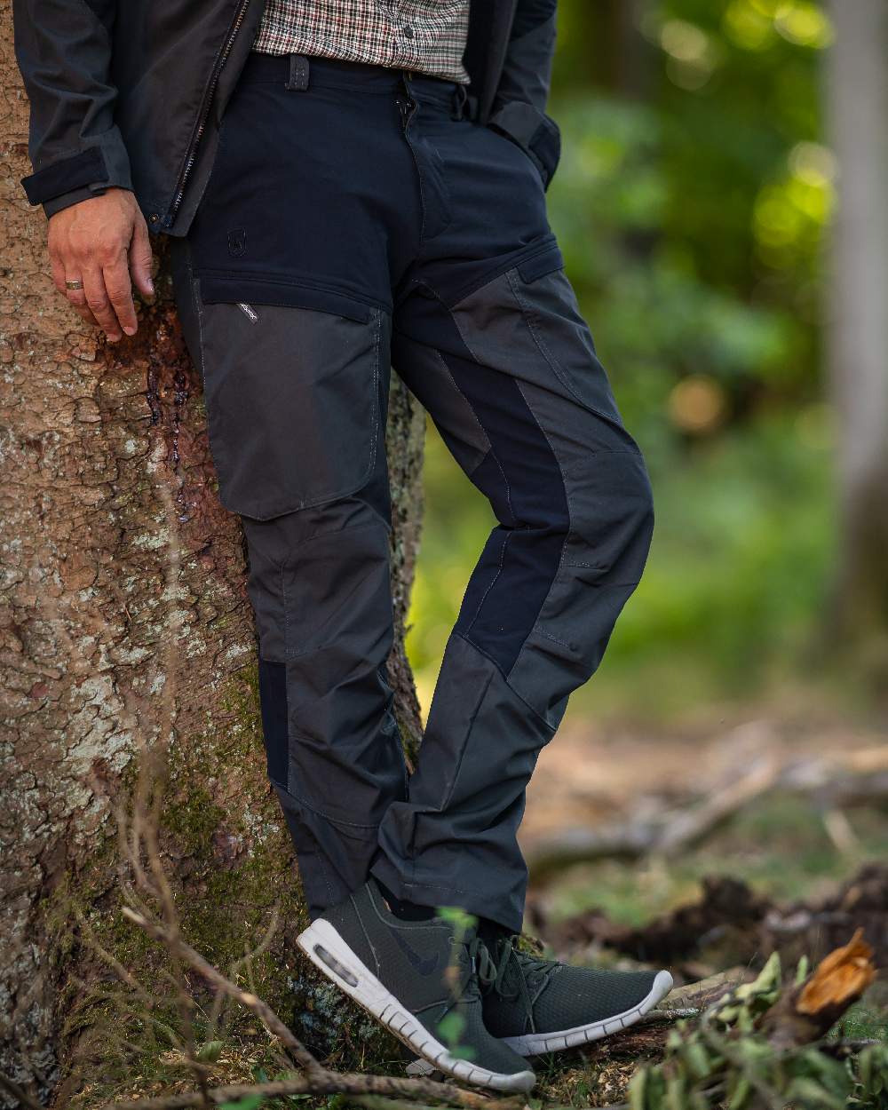 Black Ink coloured Deerhunter Strike Trousers on forest background #colour_black-ink