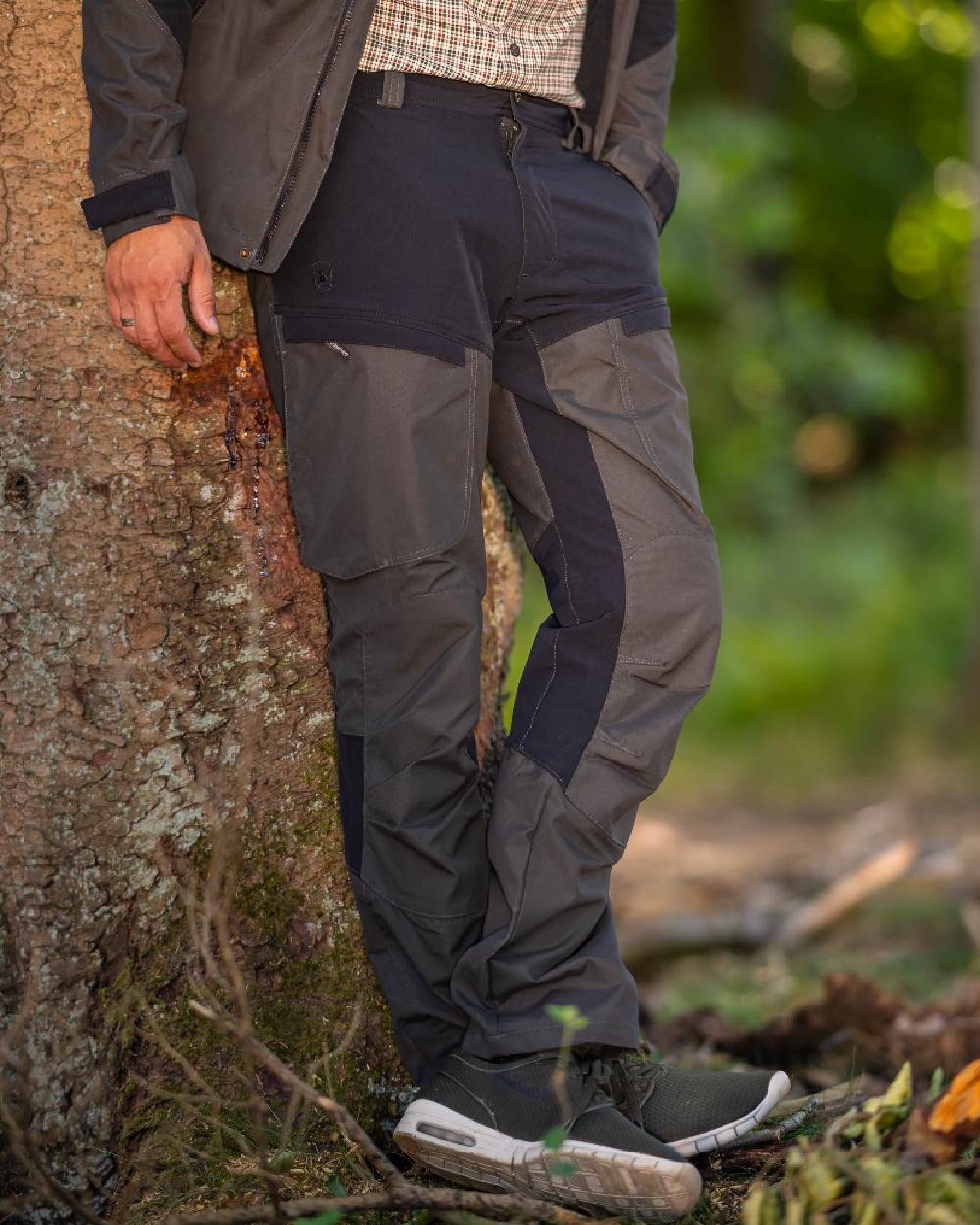 Black Ink coloured Deerhunter Strike Trousers on forest background #colour_black-ink