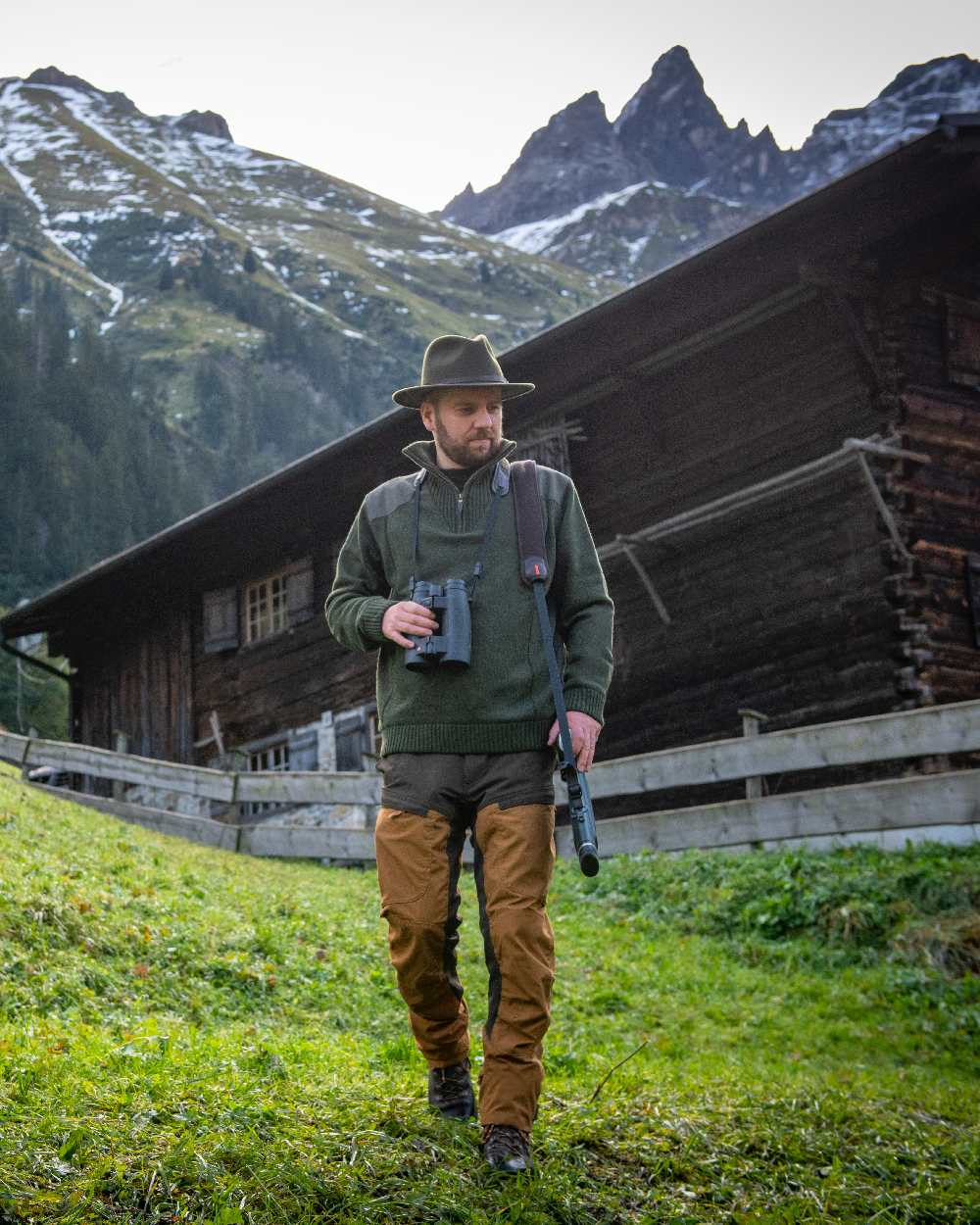 Bronze coloured Deerhunter Strike Trousers on mountain background #colour_bronze