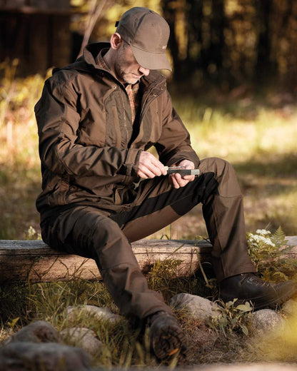 Fallen Leaf coloured Deerhunter Strike Trousers on forest background #colour_fallen-leaf