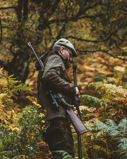 Canteen coloured Deerhunter Track Rain Jacket on forest background #colour_canteen