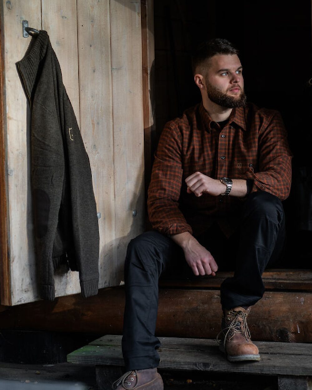 Black coloured Deerhunter Traveler Trousers on wood background #colour_black