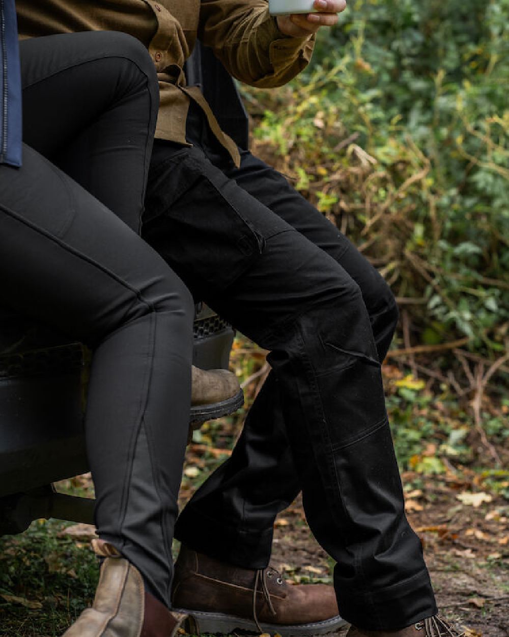 Black coloured Deerhunter Traveler Trousers on forest background #colour_black