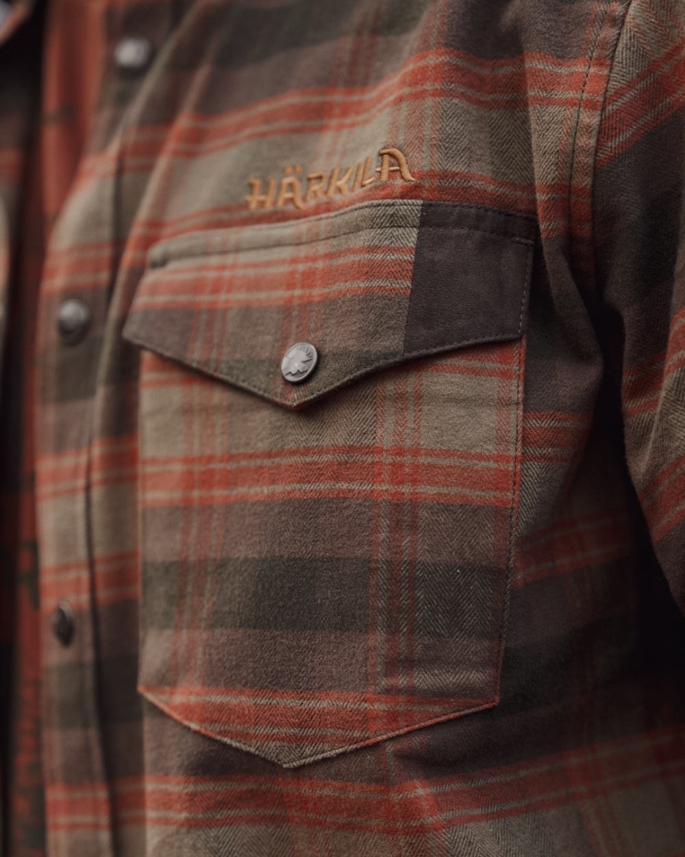 Autumn Orange Check coloured Harkila Aivak Long Sleeved Shirt on forest background #colour_autumn-orange-check