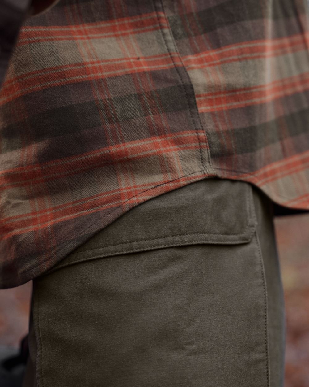 Autumn Orange Check coloured Harkila Aivak Long Sleeved Shirt on forest background #colour_autumn-orange-check