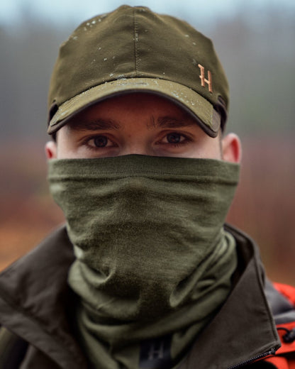 Dark Olive Coloured Harkila Base All Season Tubular Limited Edition on outdoor background #colour_dark-olive