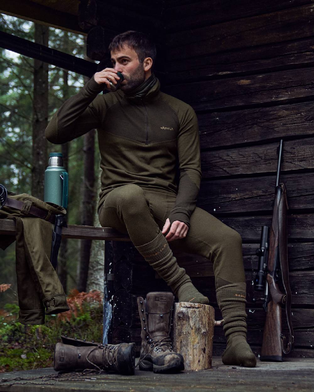 Willow Green Shadow Brown Coloured Harkila Base Warm Zip Neck on countryside background #colour_willow-green-shadow-brown