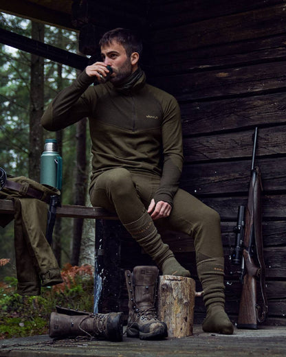 Willow Green Shadow Brown Coloured Harkila Base Warm Zip Neck on countryside background #colour_willow-green-shadow-brown