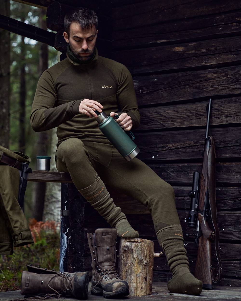Willow Green Shadow Brown Coloured Harkila Base Warm Zip Neck on countryside background #colour_willow-green-shadow-brown