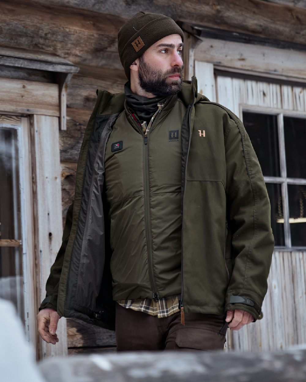 Willow Green Coloured Harkila Clim8 Base Waistcoat on house background #colour_willow-green